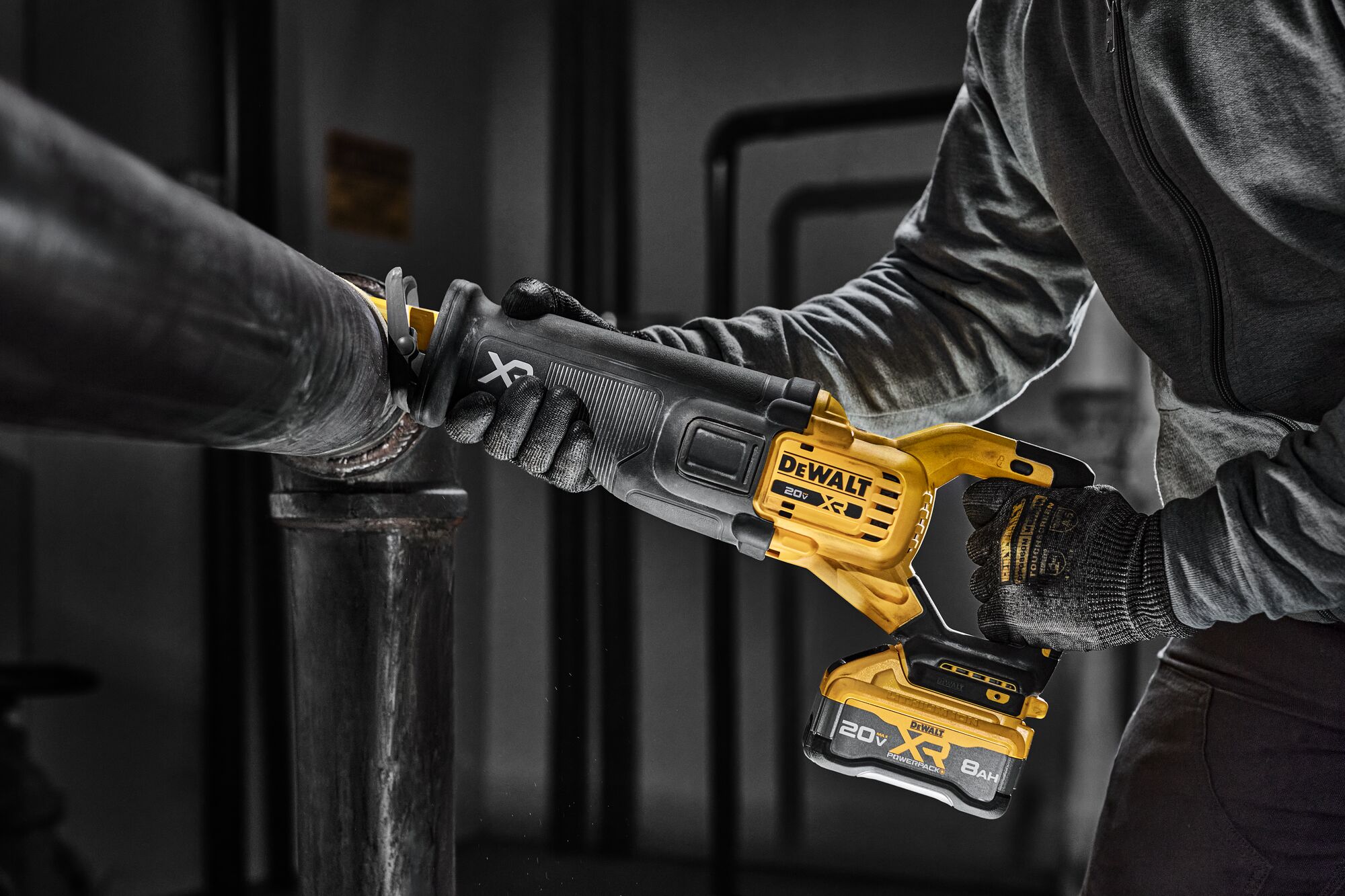 User cutting into wood material using the DCS384 reciprocating saw framing application with XR POWERPACK battery