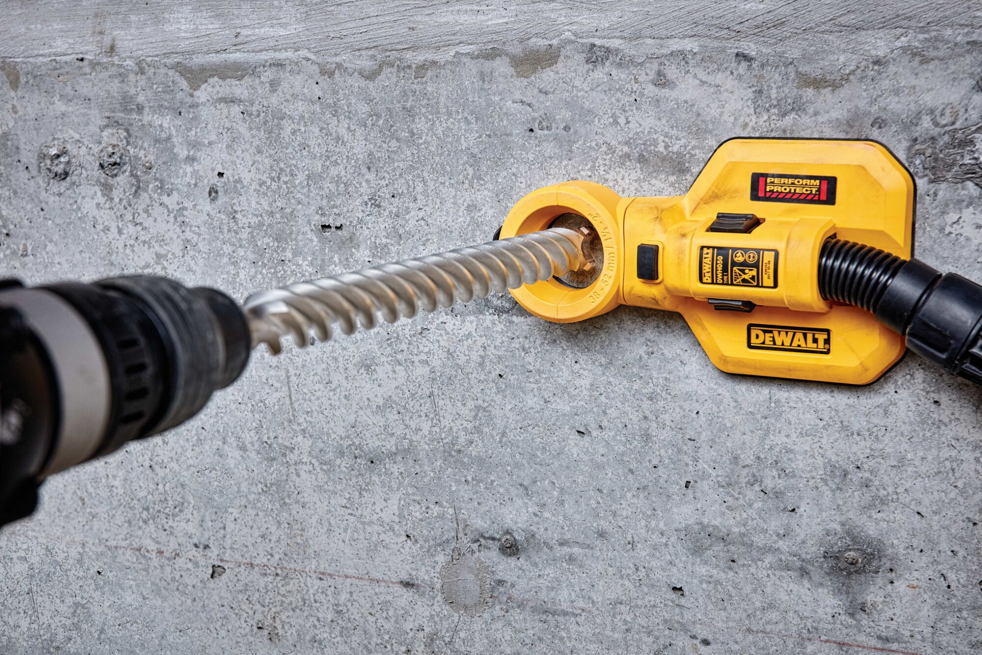 SDS Max High Impact Carbide 4 Cutter Drill Bit in use on concrete wall.