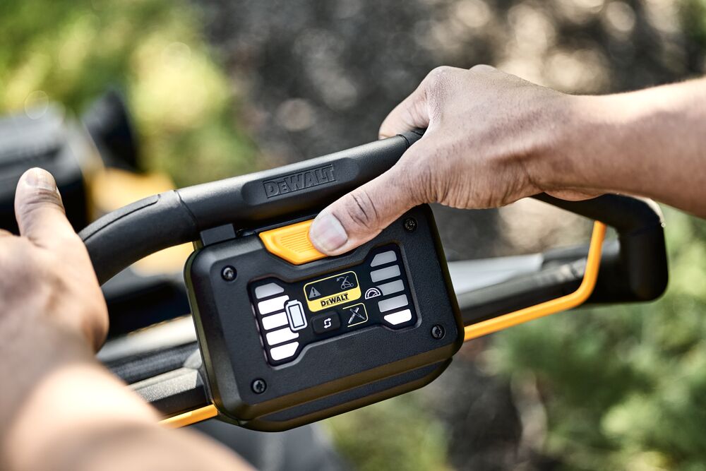 LED Dashboard showing high battery life and low grass height as landscaper is mowing lawn