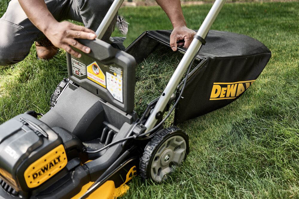 Landscaper holding grass bag full of grass clippings