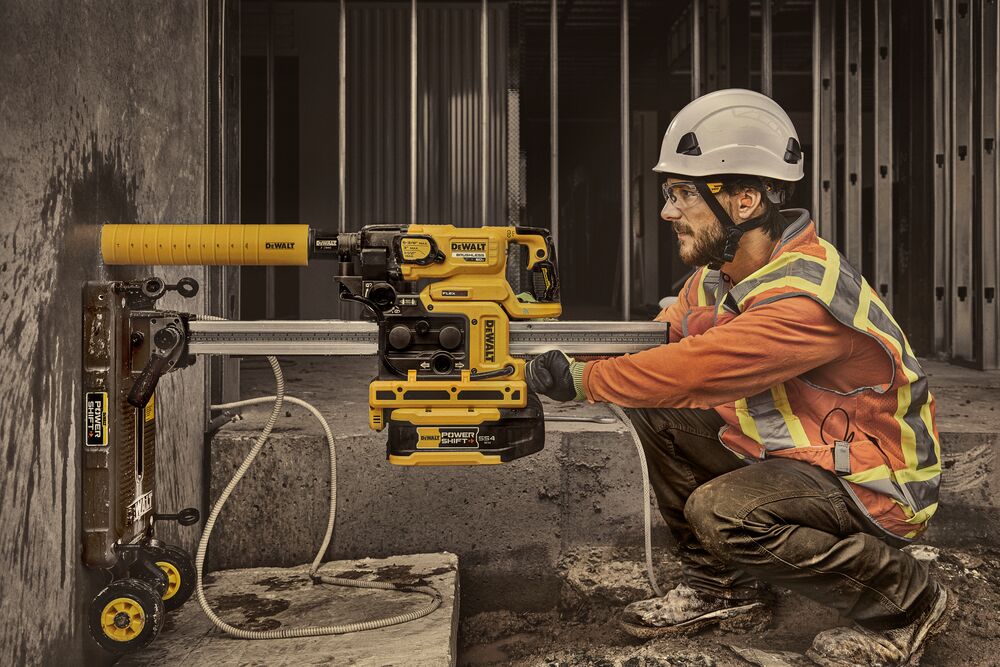 Man drilling hole in wall with core drill