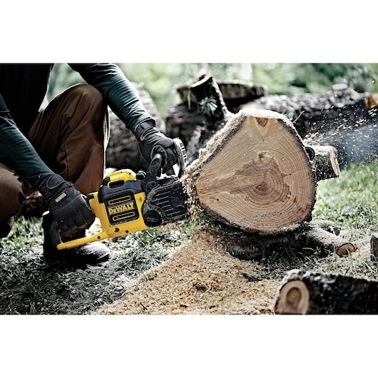 Secure Fit General Utility Work Glove being used by a person while cutting wood.